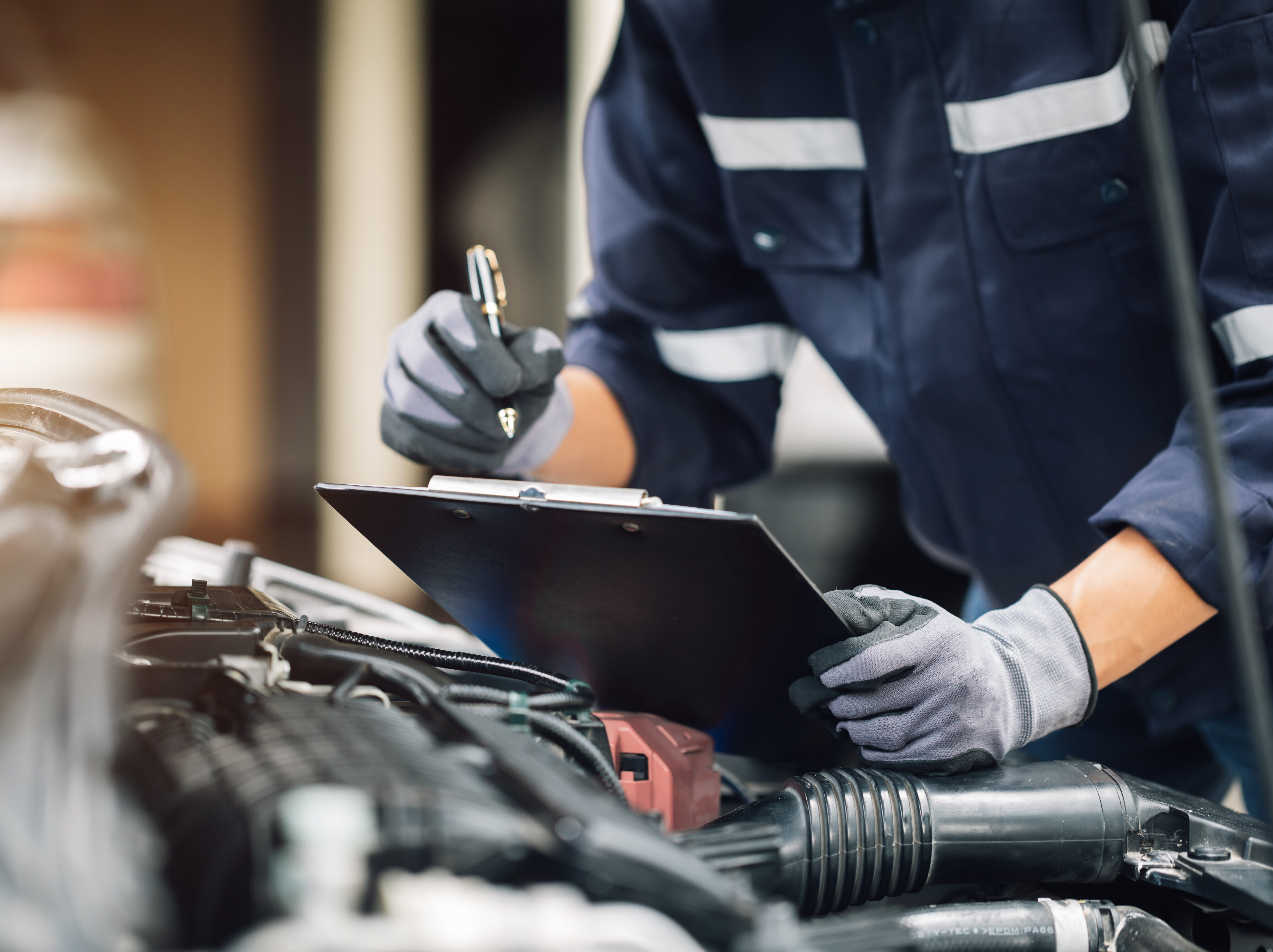 Mechanic works on the engine of the car in the garage. Repair se